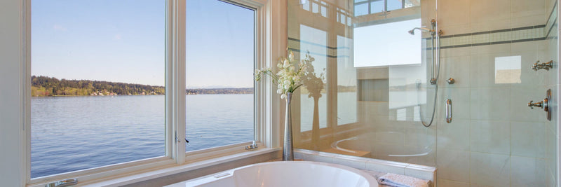 Bright bathroom with a frameless glass shower beside a soaking tub